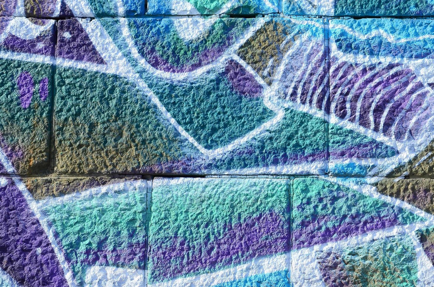 Fragment of graffiti drawings. The old wall decorated with paint stains in the style of street art culture. Colored background texture in cold tones photo