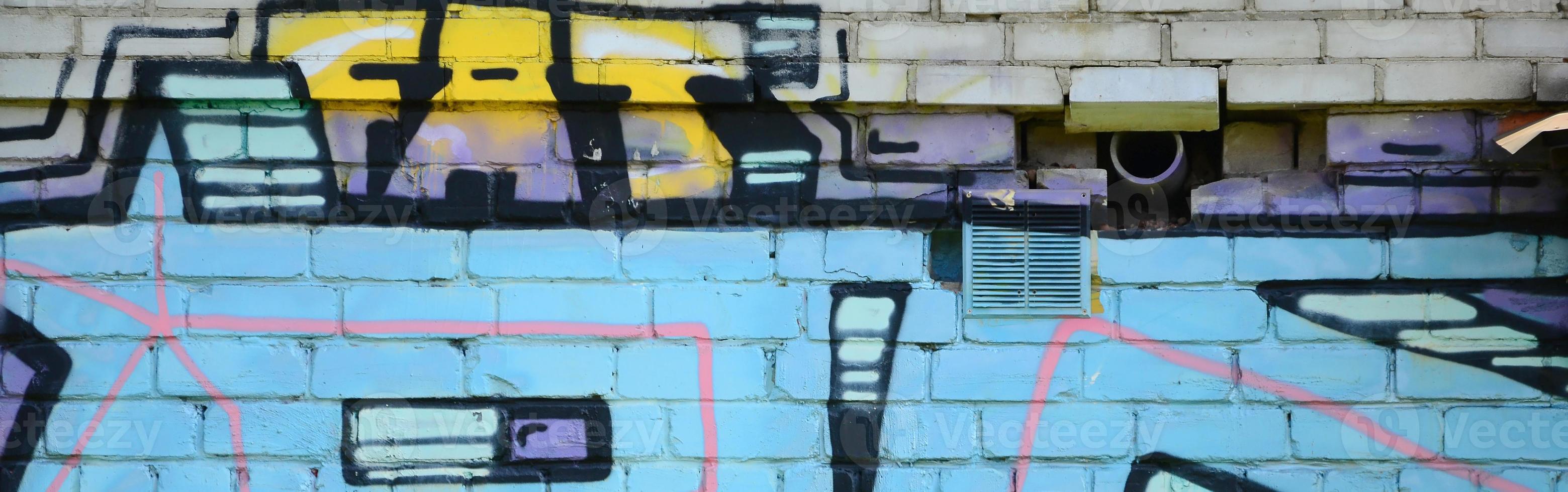 Fragment of graffiti drawings. The old wall decorated with paint stains in the style of street art culture. Colored background texture in cold tones photo