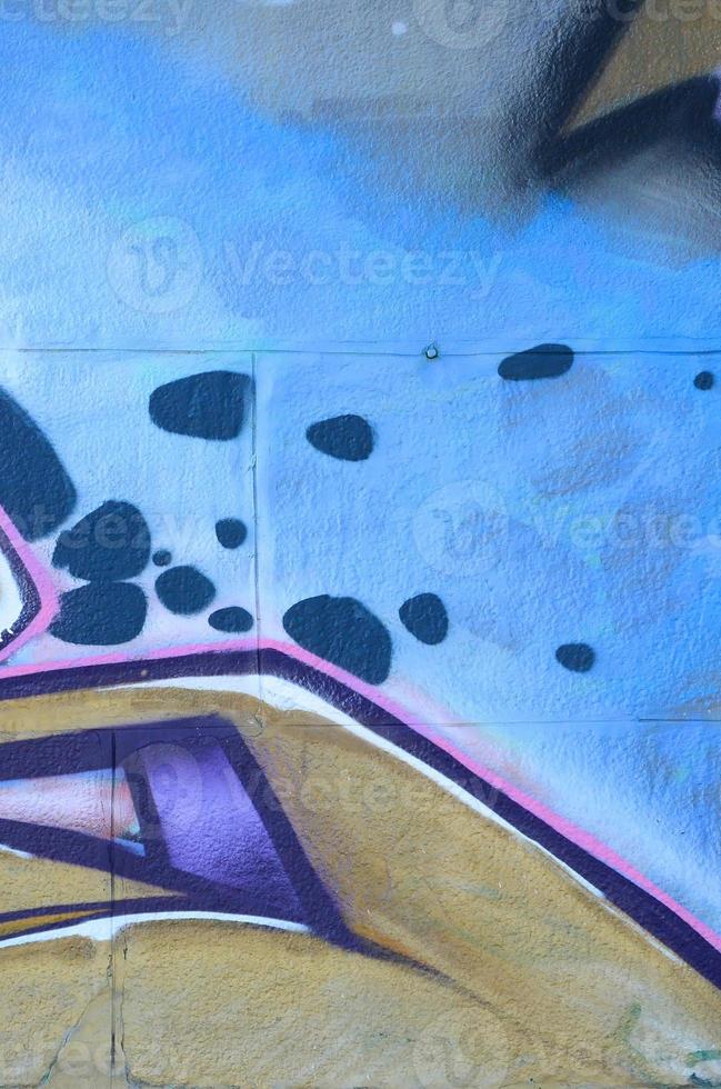 Fragment of graffiti drawings. The old wall decorated with paint stains in the style of street art culture. Colored background texture in purple tones photo