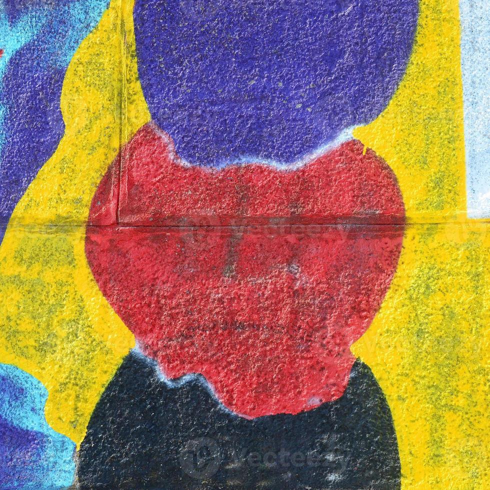 Fragment of graffiti drawings. The old wall decorated with paint stains in the style of street art culture. Multicolored background texture photo