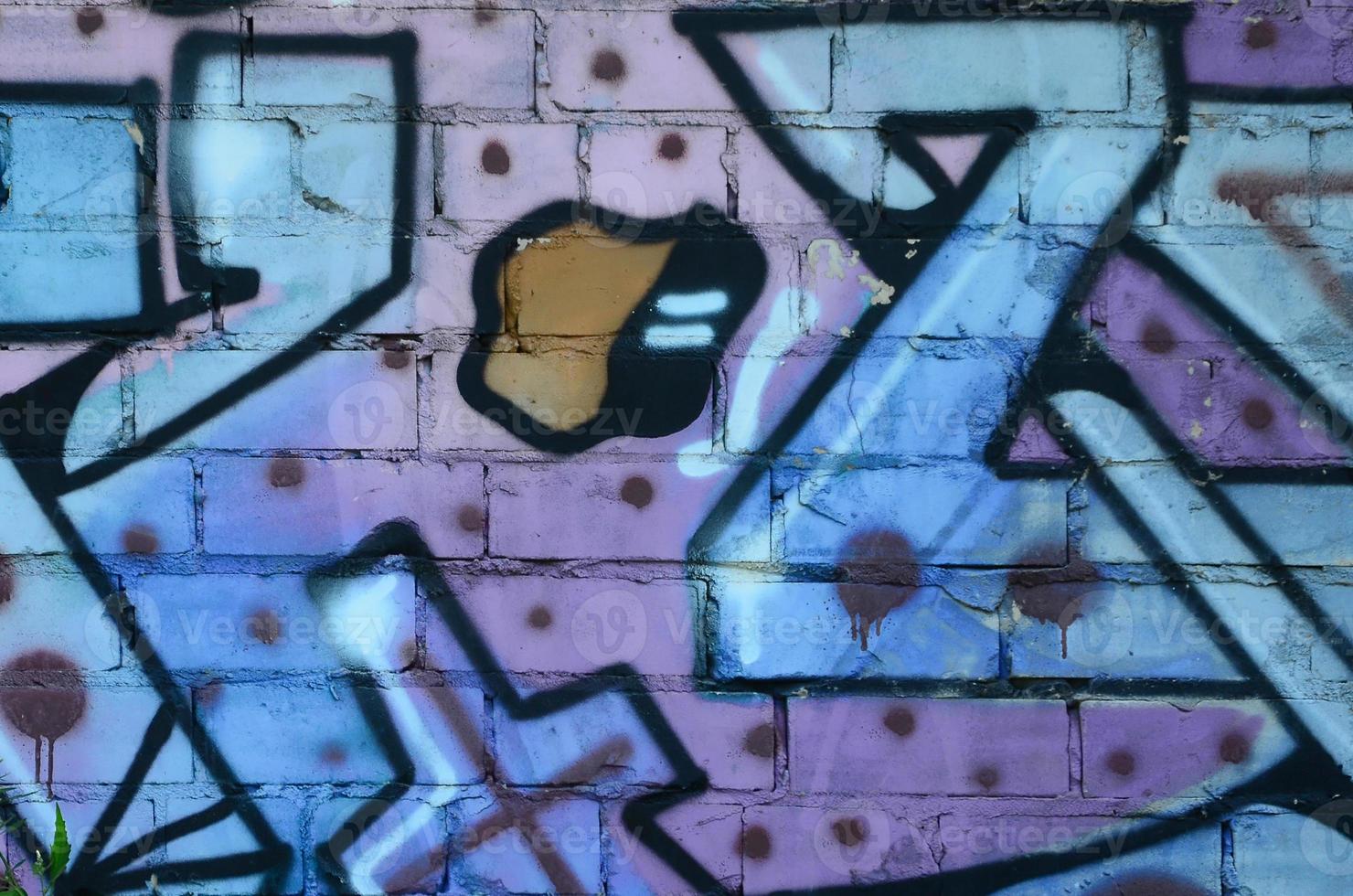 Fragment of graffiti drawings. The old wall decorated with paint stains in the style of street art culture. Colored background texture in cold tones photo