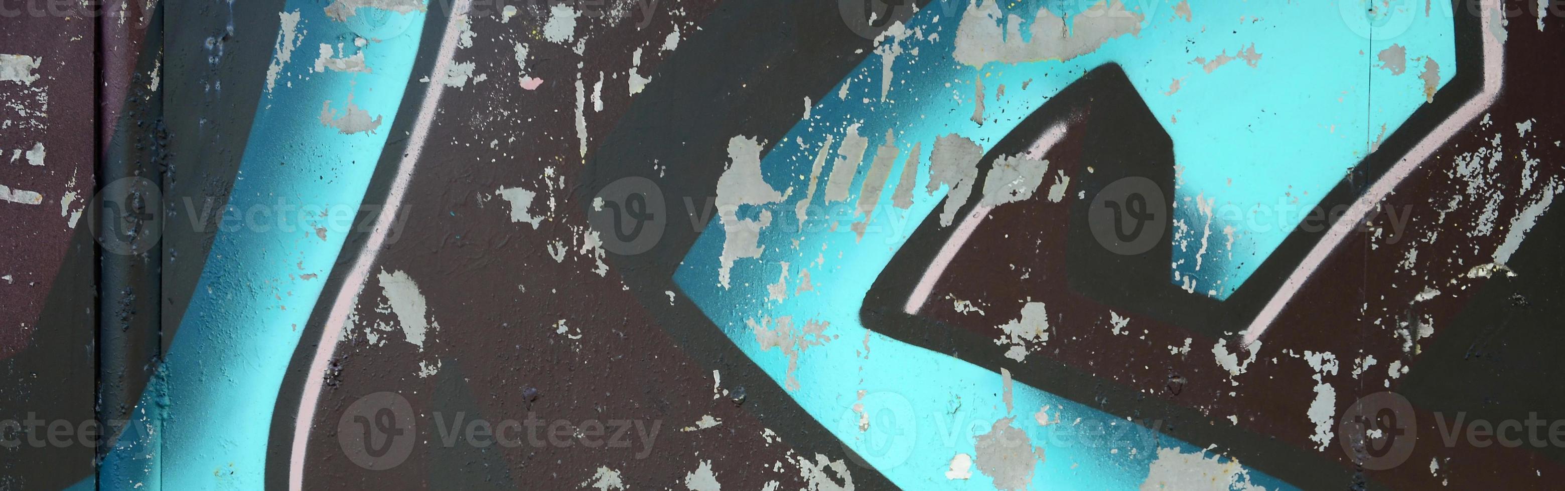 Fragment of graffiti drawings. The old wall decorated with paint stains in the style of street art culture. Colored background texture in cold tones photo