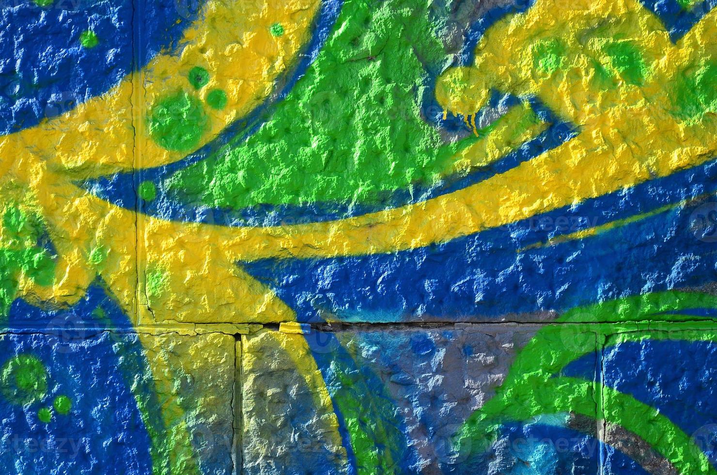 Fragment of graffiti drawings. The old wall decorated with paint stains in the style of street art culture. Colored background texture in green tones photo