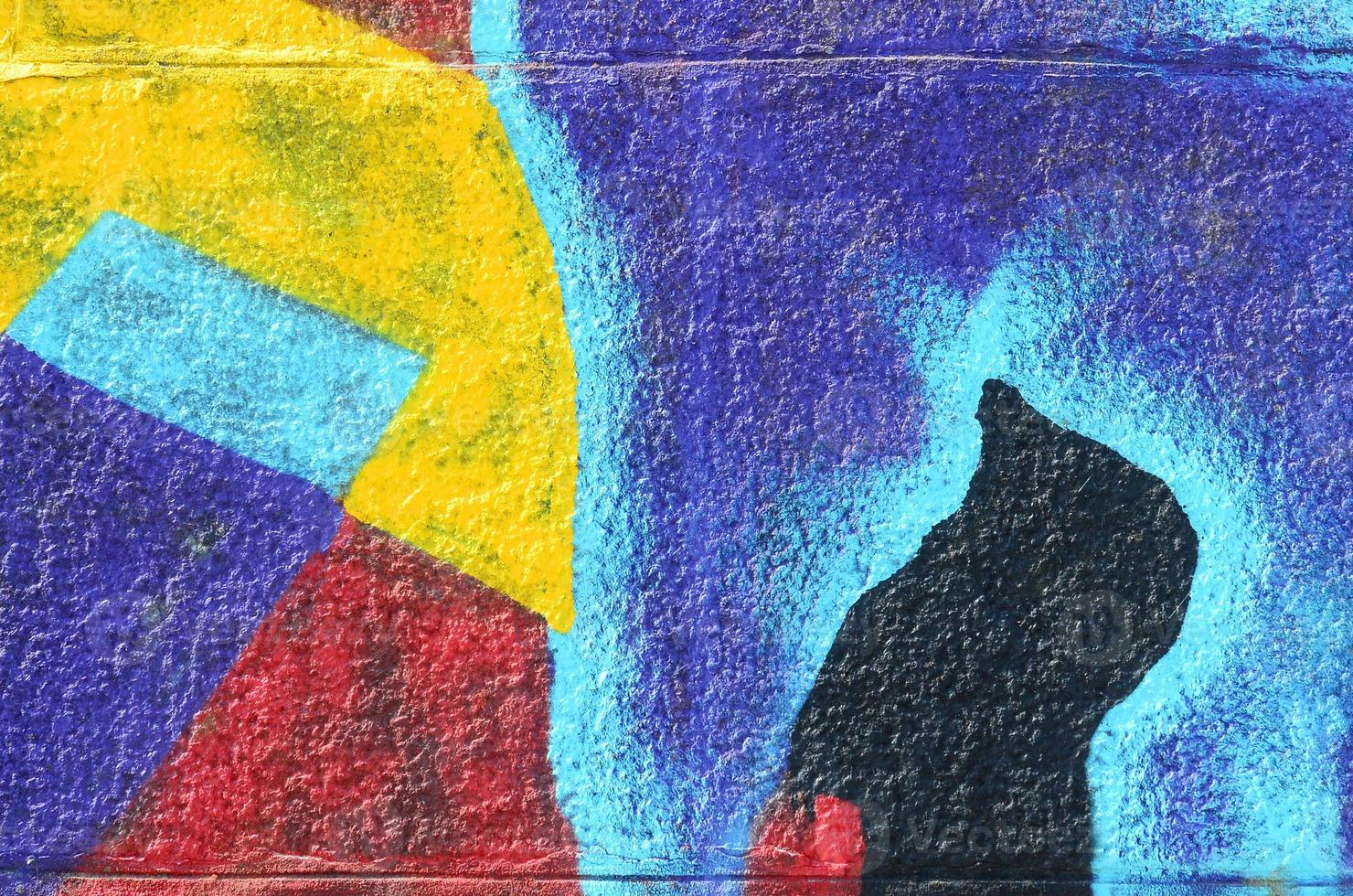 Fragment of graffiti drawings. The old wall decorated with paint stains in the style of street art culture. Multicolored background texture photo