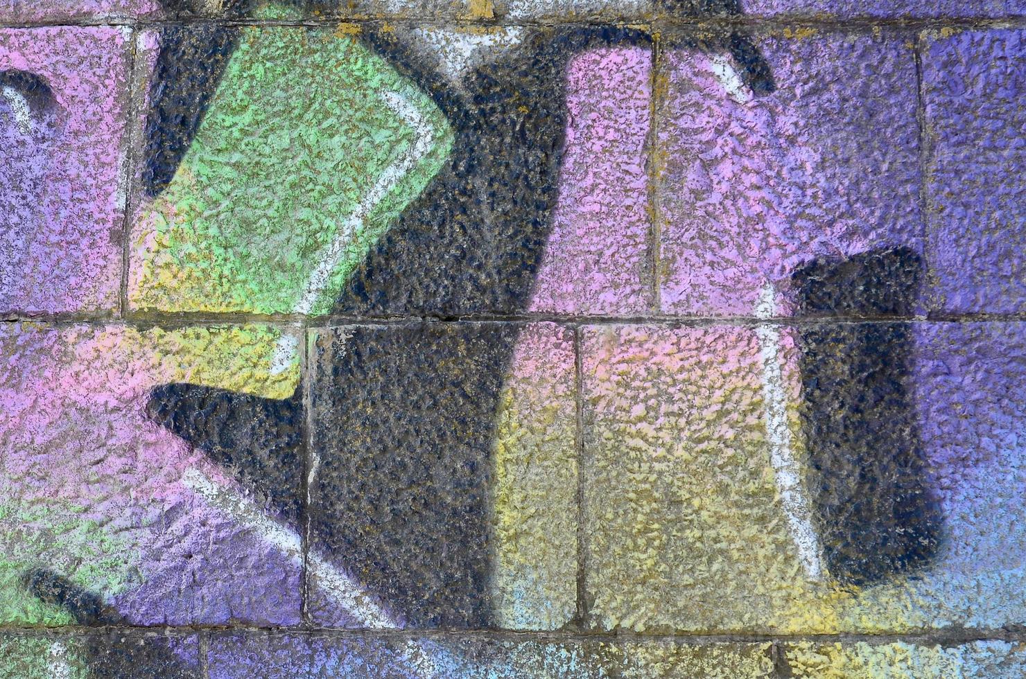 Fragment of graffiti drawings. The old wall decorated with paint stains in the style of street art culture. Multicolored background texture photo