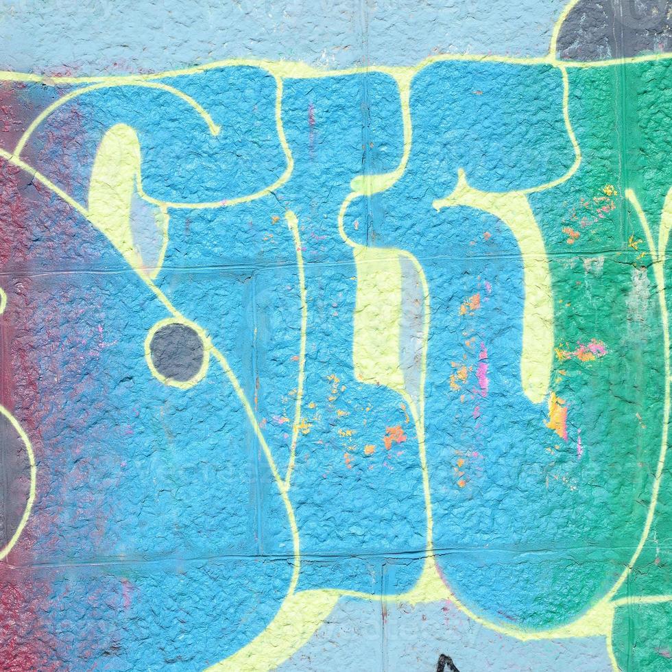 Fragment of graffiti drawings. The old wall decorated with paint stains in the style of street art culture. Colored background texture in cold tones photo