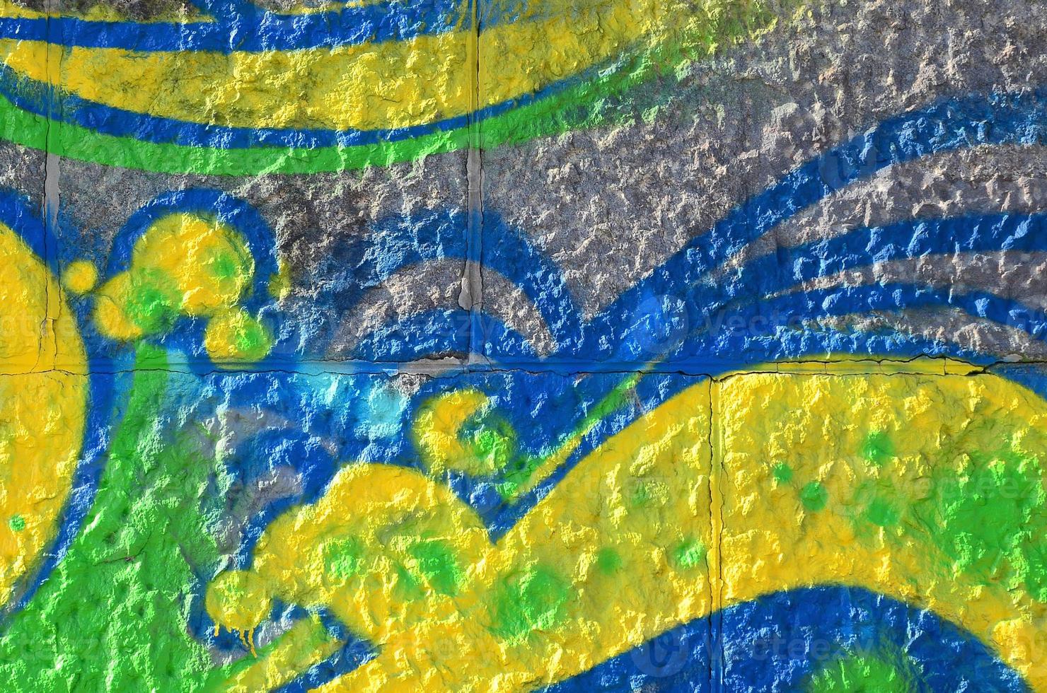 Fragment of graffiti drawings. The old wall decorated with paint stains in the style of street art culture. Colored background texture in green tones photo