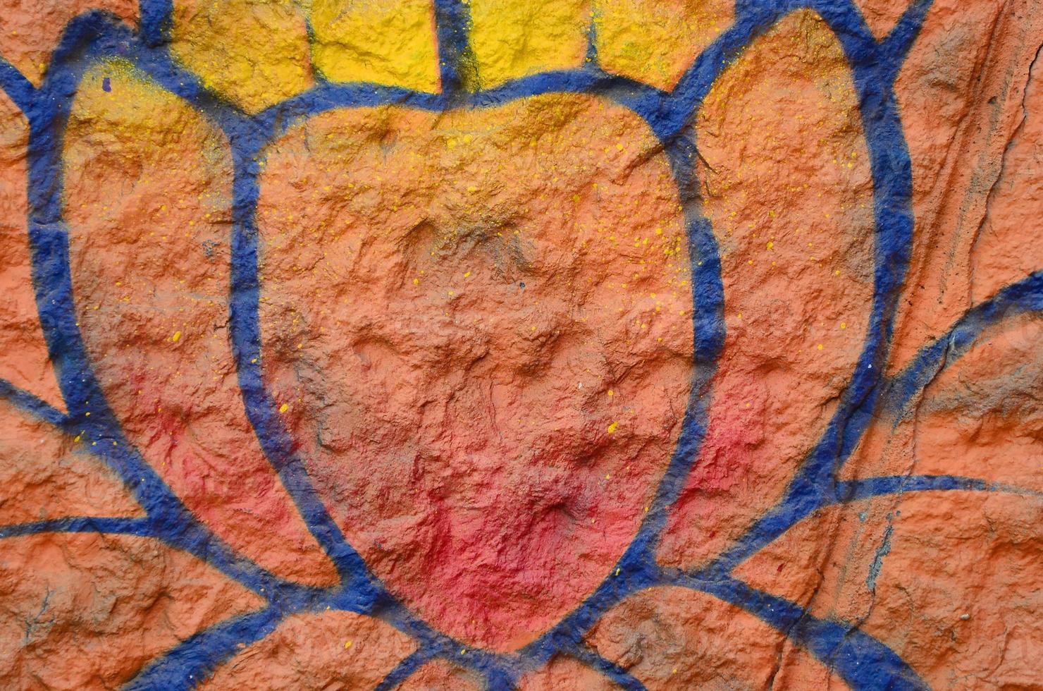 Fragment of graffiti drawings. The old wall decorated with paint stains in the style of street art culture. Orange flower photo