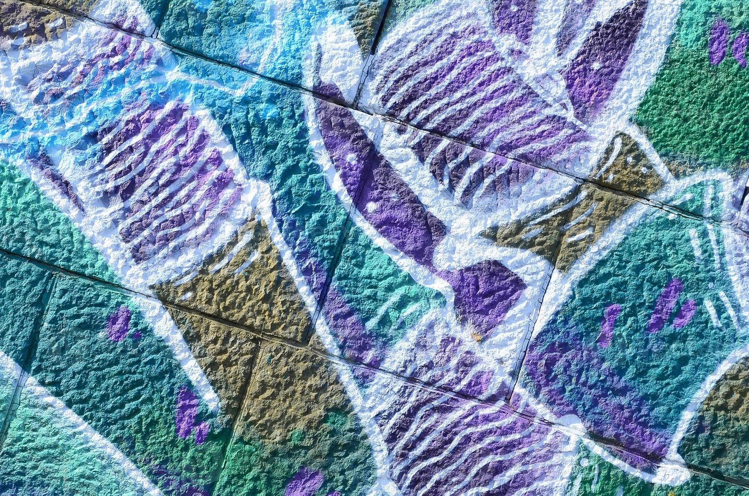 Fragment of graffiti drawings. The old wall decorated with paint stains in the style of street art culture. Colored background texture in cold tones photo