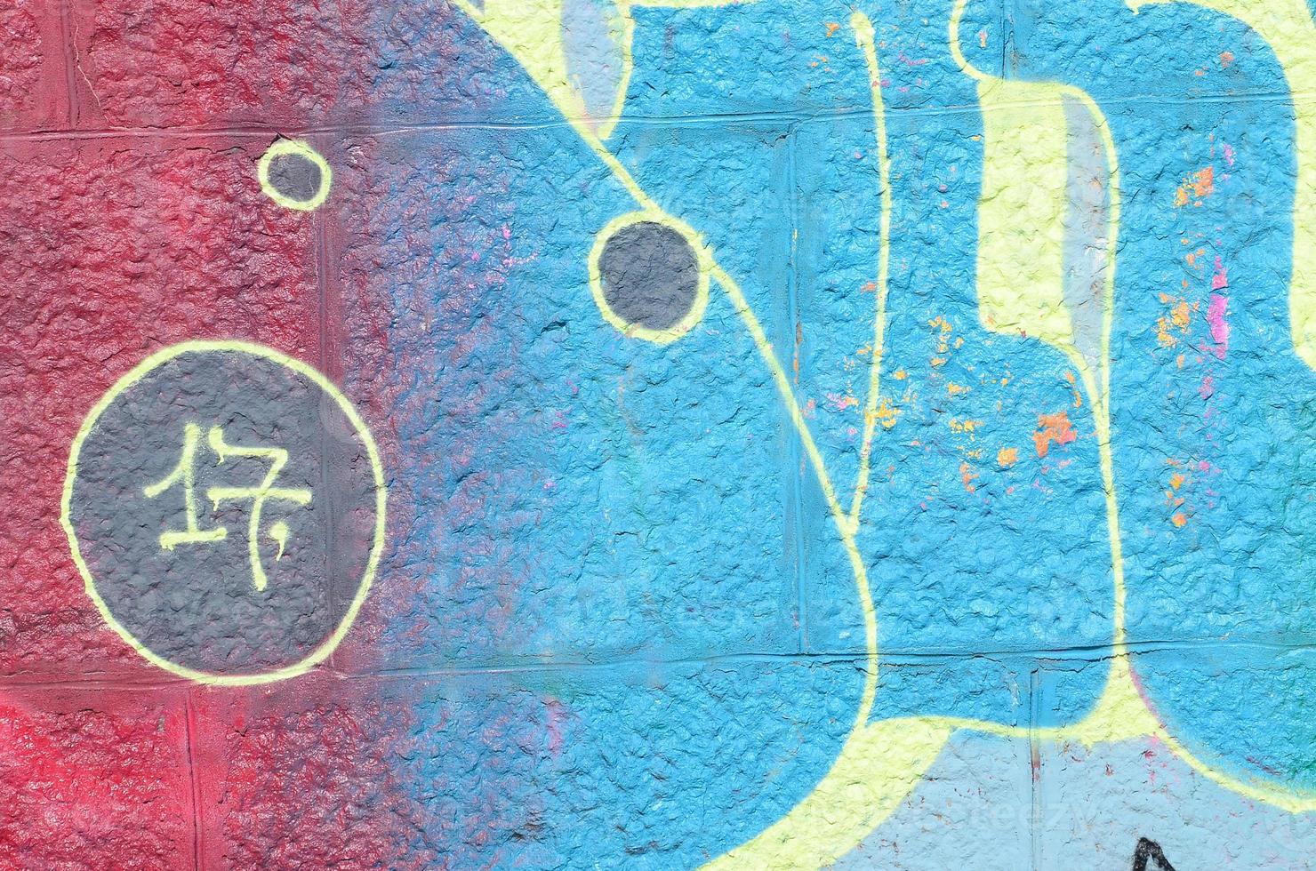 Fragment of graffiti drawings. The old wall decorated with paint stains in the style of street art culture. Colored background texture in cold tones photo