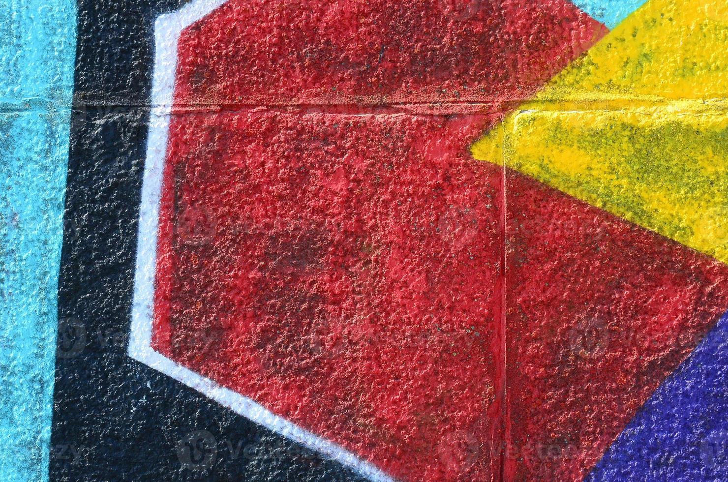 Fragment of graffiti drawings. The old wall decorated with paint stains in the style of street art culture. Multicolored background texture photo