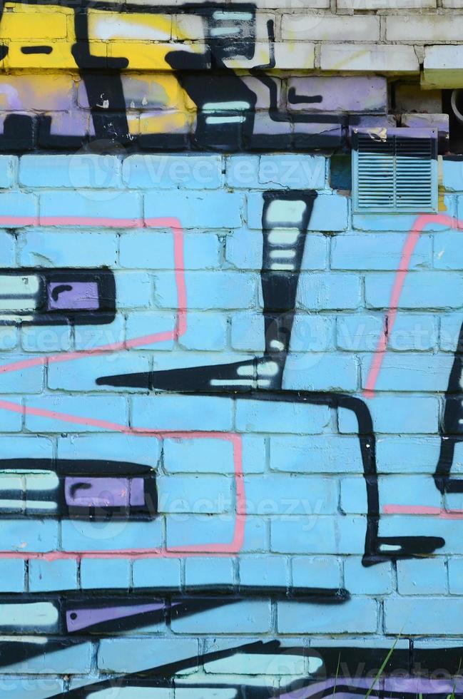 Fragment of graffiti drawings. The old wall decorated with paint stains in the style of street art culture. Colored background texture in cold tones photo