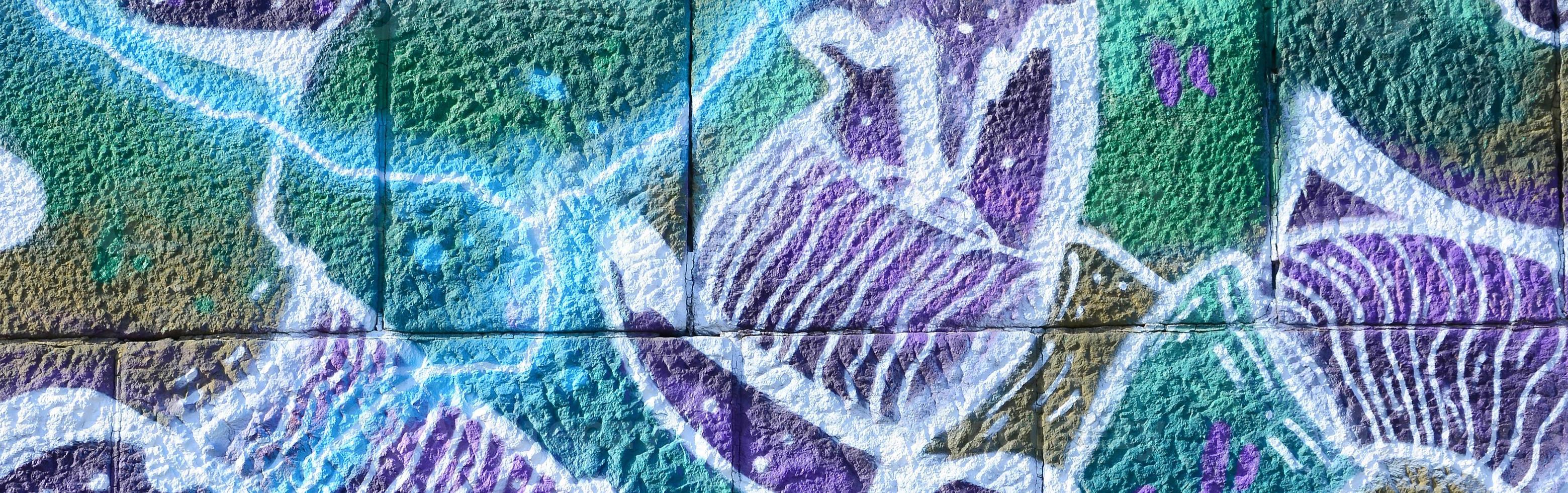Fragment of graffiti drawings. The old wall decorated with paint stains in the style of street art culture. Colored background texture in cold tones photo