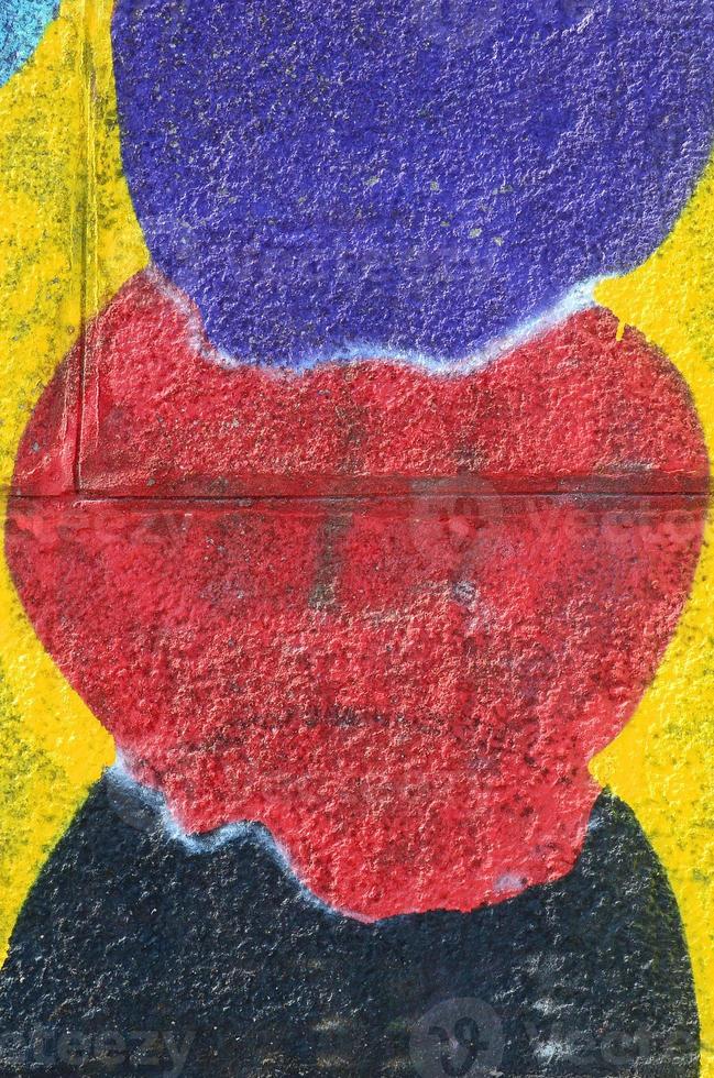 Fragment of graffiti drawings. The old wall decorated with paint stains in the style of street art culture. Multicolored background texture photo