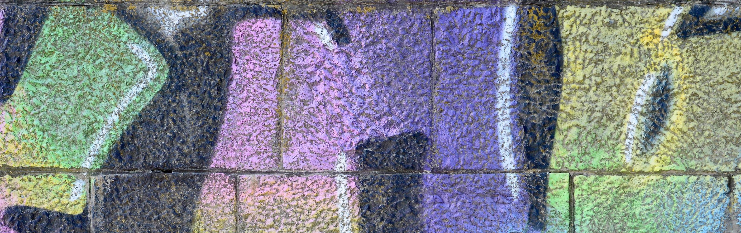 Fragment of graffiti drawings. The old wall decorated with paint stains in the style of street art culture. Multicolored background texture photo