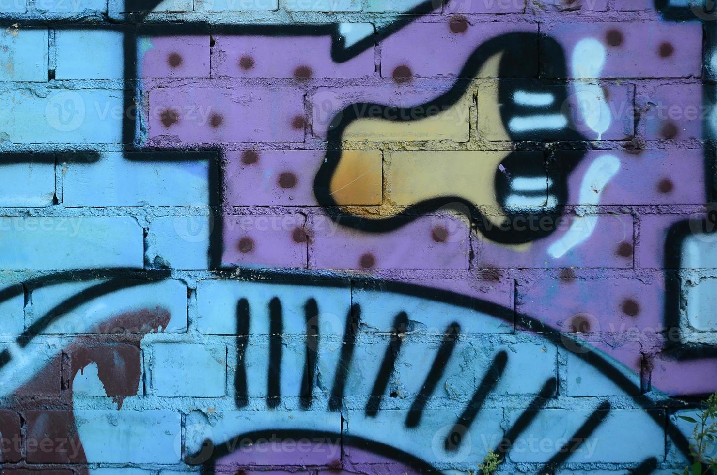 Fragment of graffiti drawings. The old wall decorated with paint stains in the style of street art culture. Colored background texture in cold tones photo