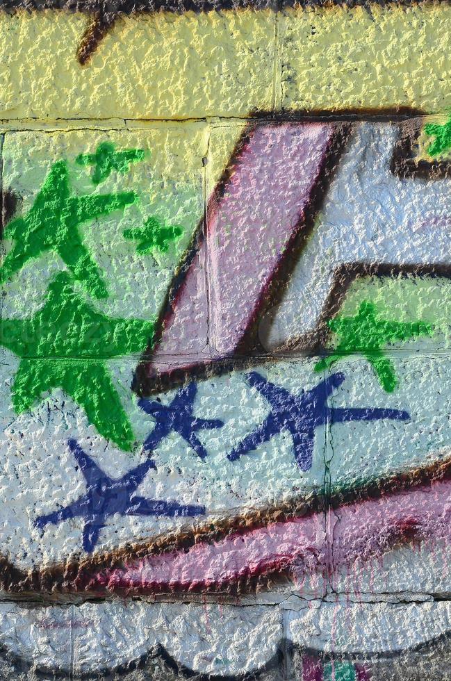 Fragment of graffiti drawings. The old wall decorated with paint stains in the style of street art culture. Colored background texture in green tones photo