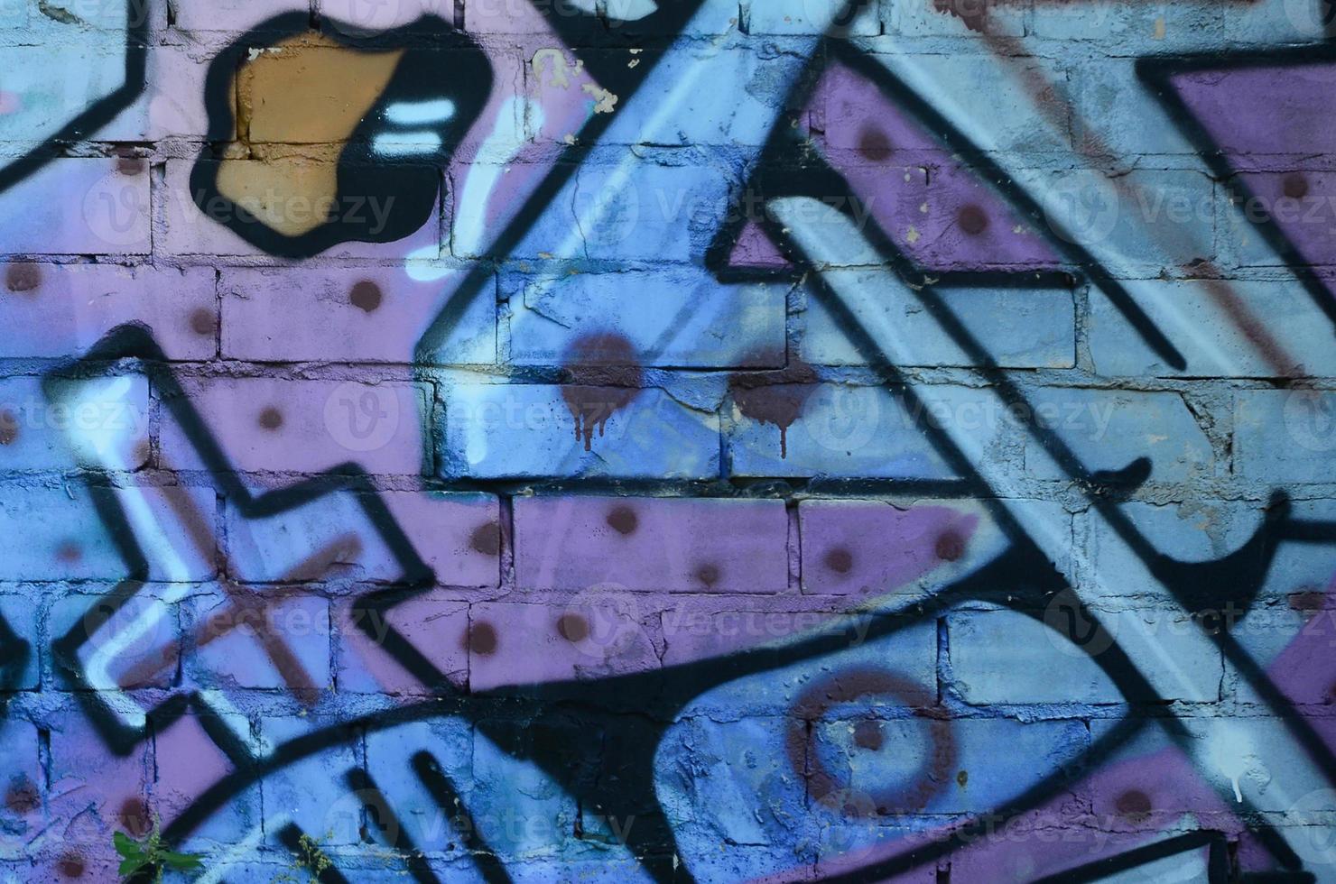Fragment of graffiti drawings. The old wall decorated with paint stains in the style of street art culture. Colored background texture in cold tones photo