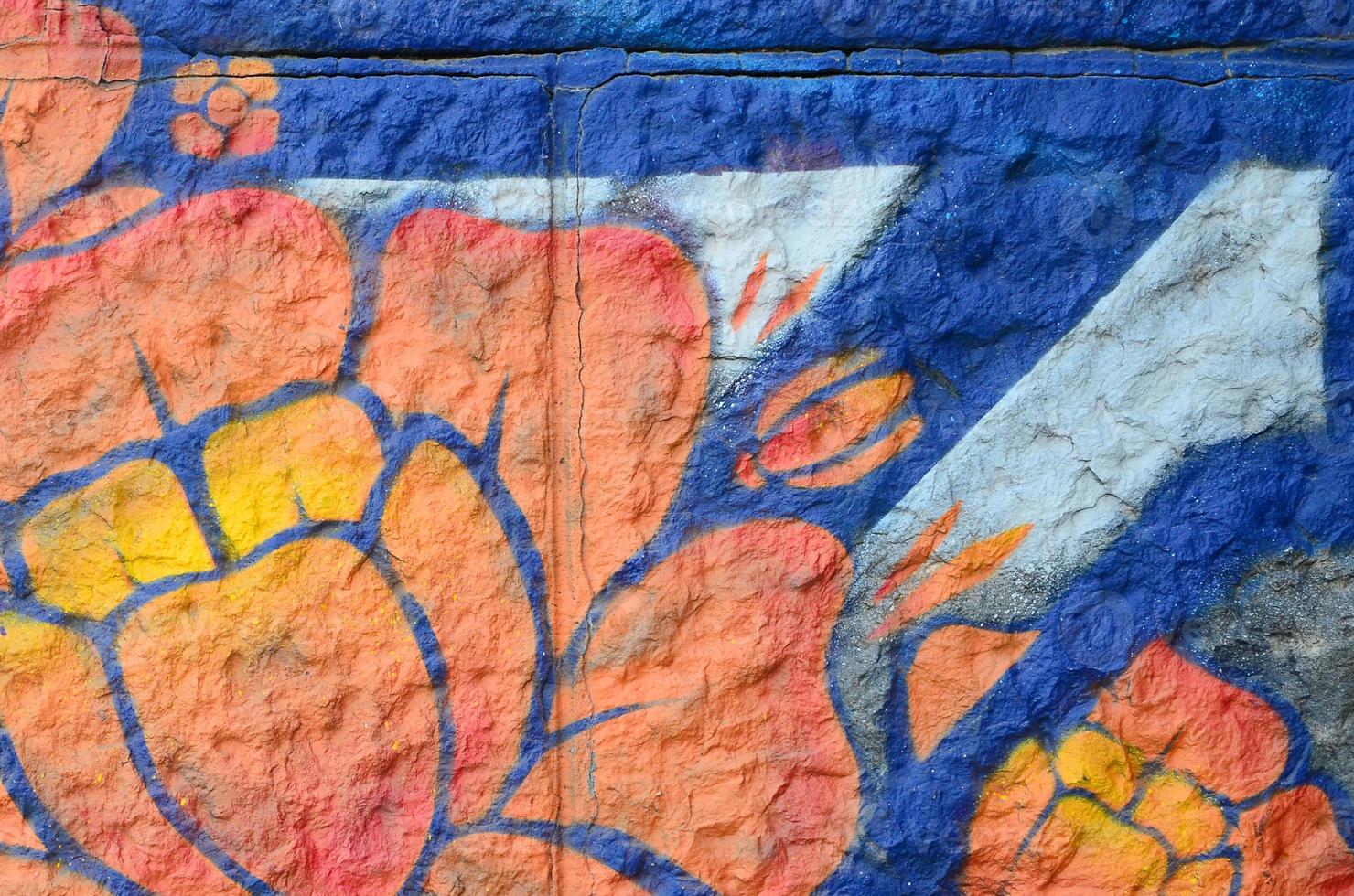 Fragment of graffiti drawings. The old wall decorated with paint stains in the style of street art culture. Orange flower photo