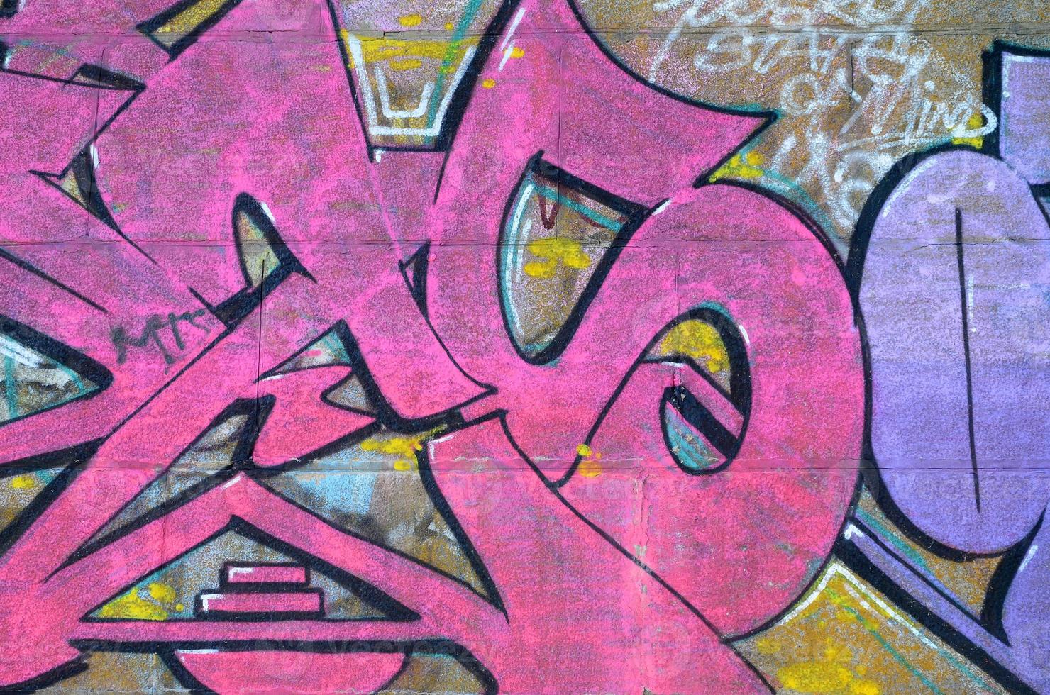 Fragment of graffiti drawings. The old wall decorated with paint stains in the style of street art culture. Colored background texture in purple tones photo