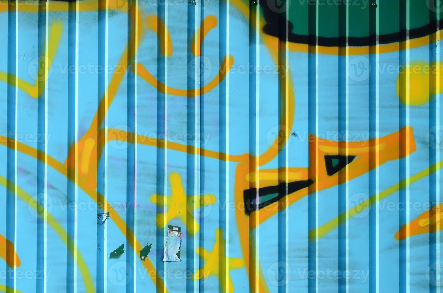 Fragment of graffiti drawings. The old wall decorated with paint stains in the style of street art culture. Colored background texture in cold tones photo