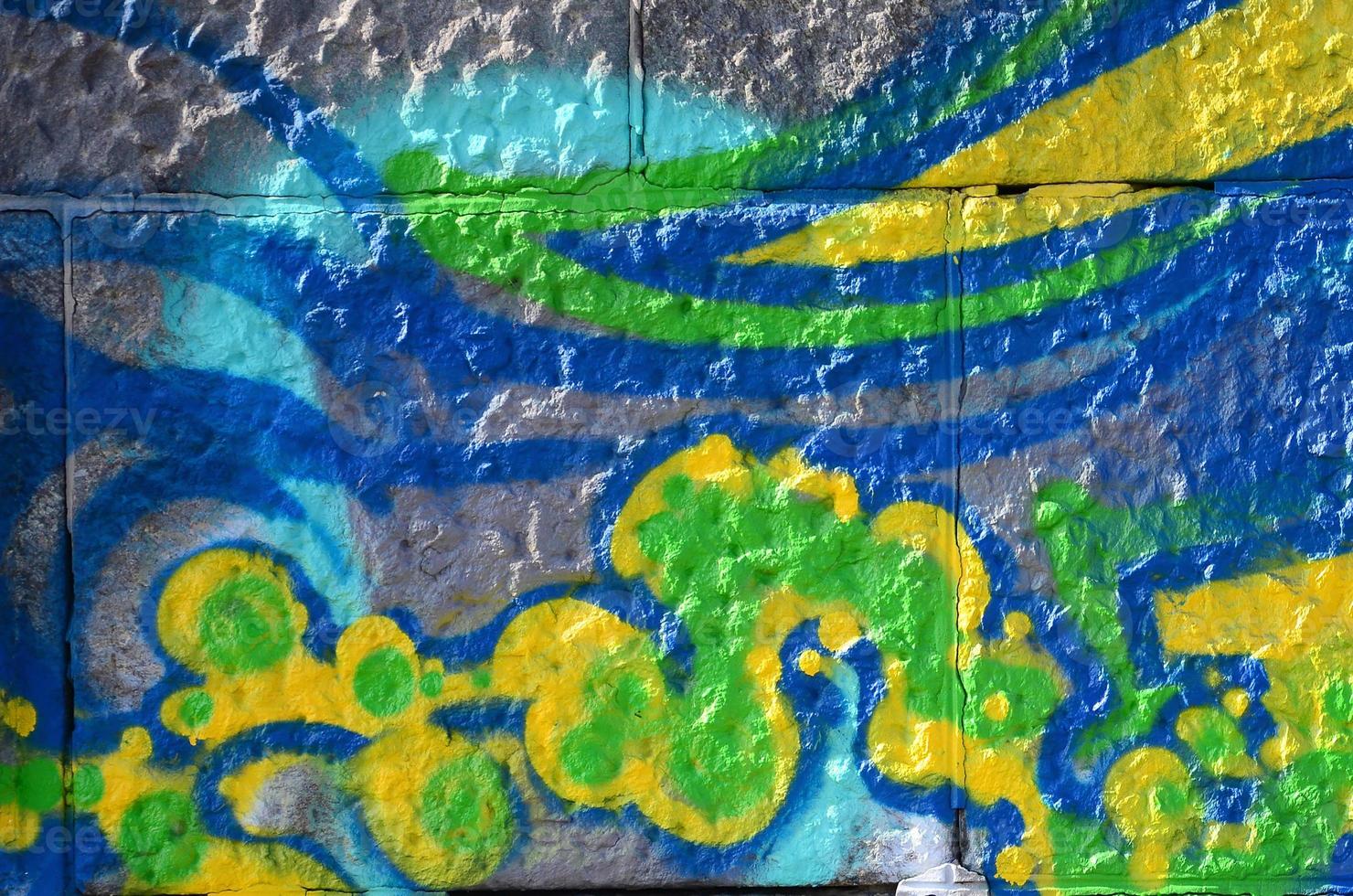 Fragment of graffiti drawings. The old wall decorated with paint stains in the style of street art culture. Colored background texture in green tones photo