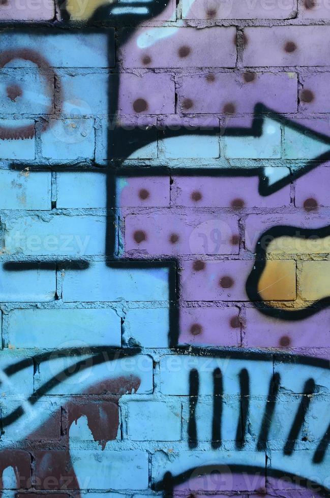 Fragment of graffiti drawings. The old wall decorated with paint stains in the style of street art culture. Colored background texture in cold tones photo