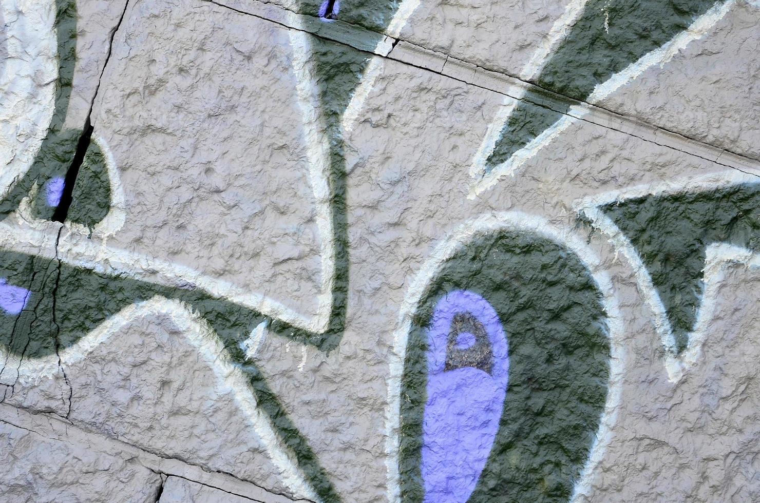 Fragment of graffiti drawings. The old wall decorated with paint stains in the style of street art culture. Colored background texture in purple tones photo