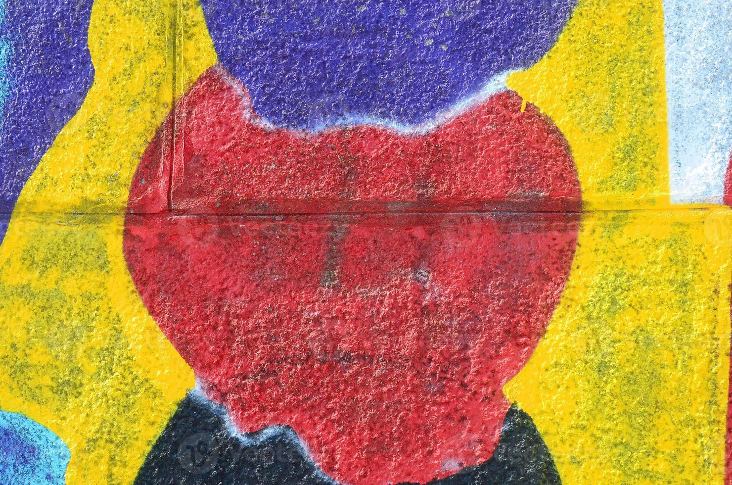 Fragment of graffiti drawings. The old wall decorated with paint stains in the style of street art culture. Multicolored background texture photo