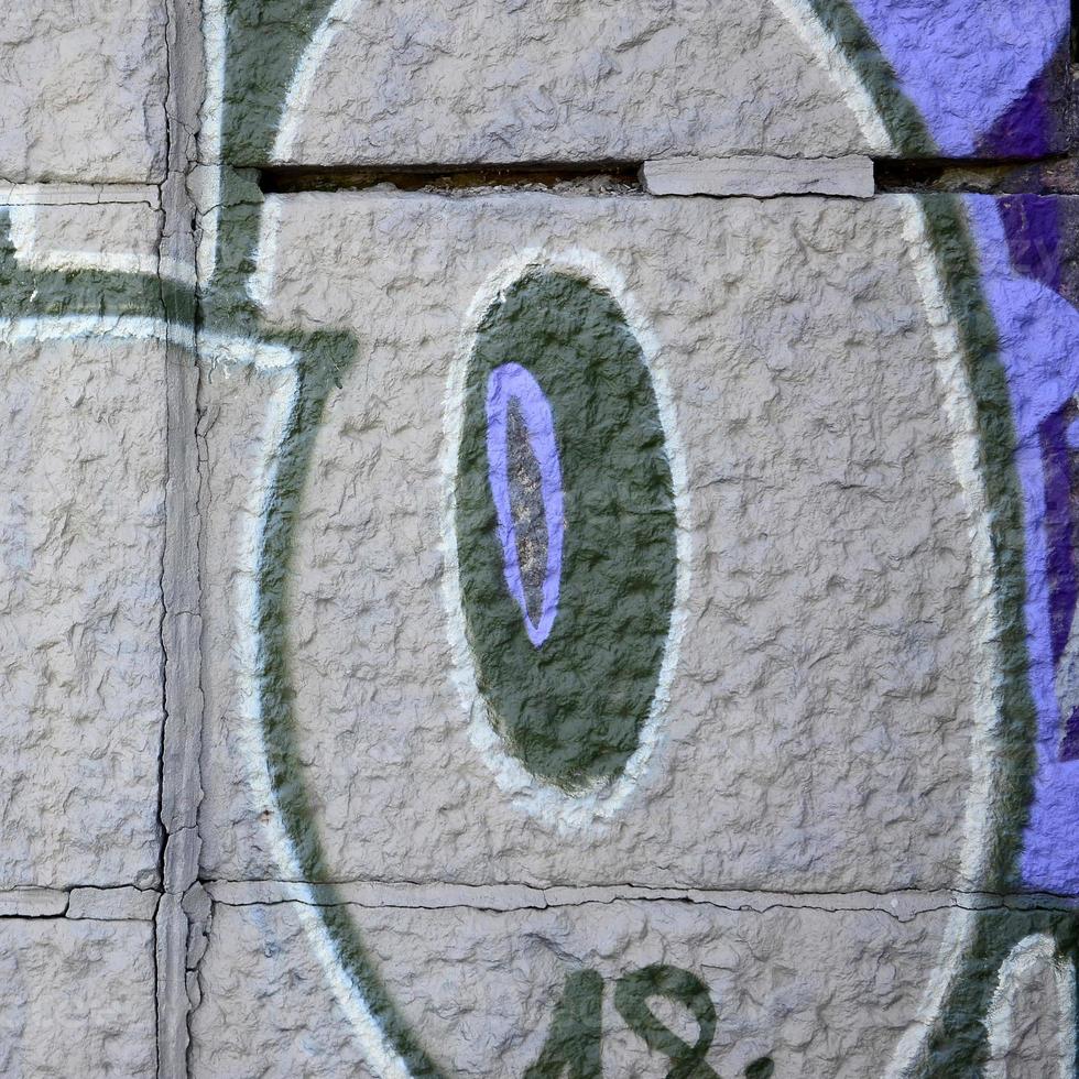 Fragment of graffiti drawings. The old wall decorated with paint stains in the style of street art culture. Colored background texture in purple tones photo