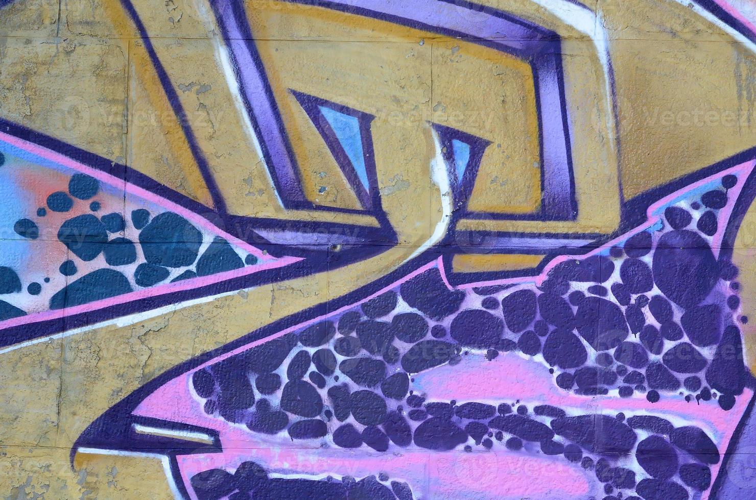 Fragment of graffiti drawings. The old wall decorated with paint stains in the style of street art culture. Colored background texture in purple tones photo