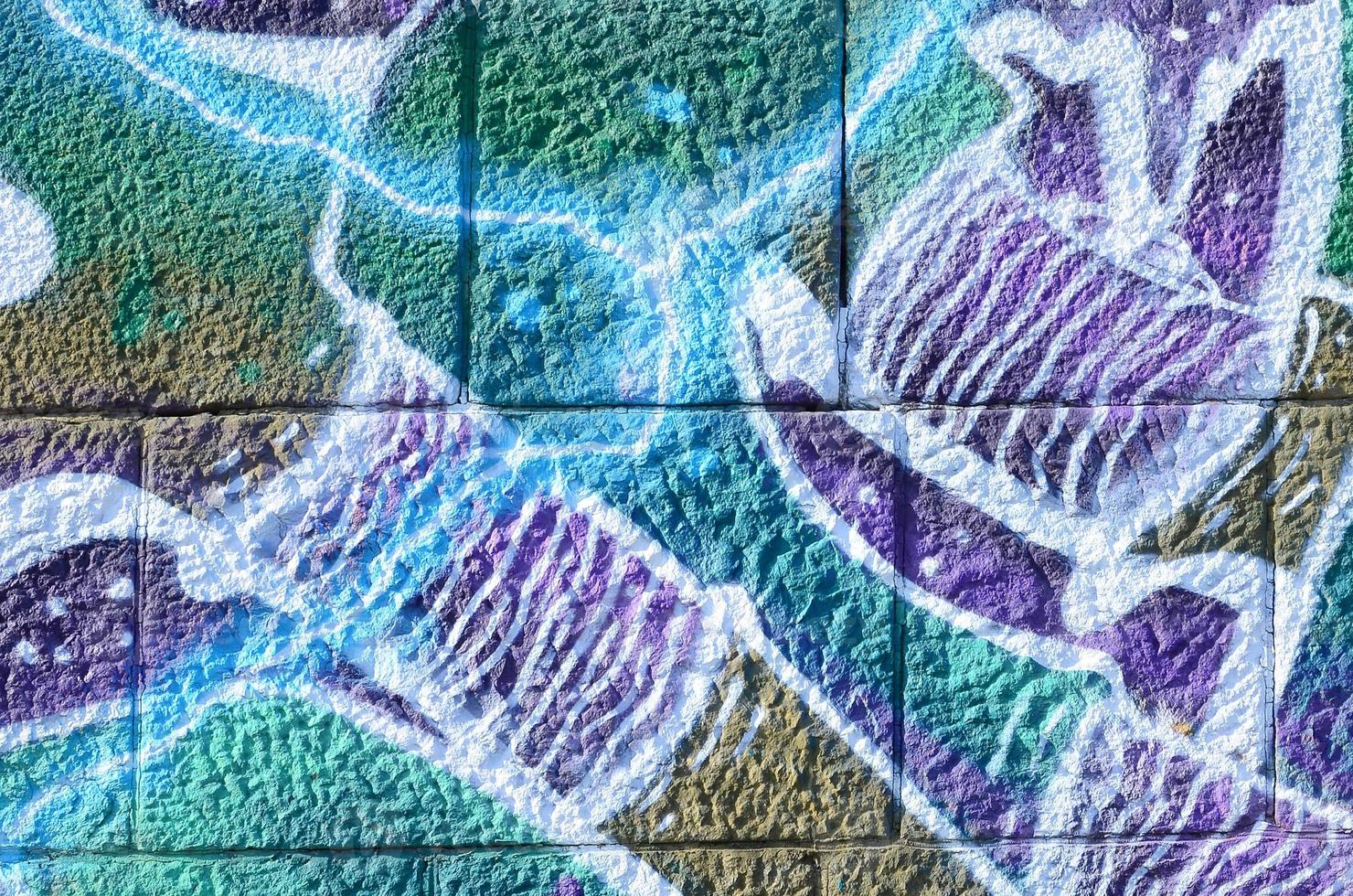 Fragment of graffiti drawings. The old wall decorated with paint stains in the style of street art culture. Colored background texture in cold tones photo