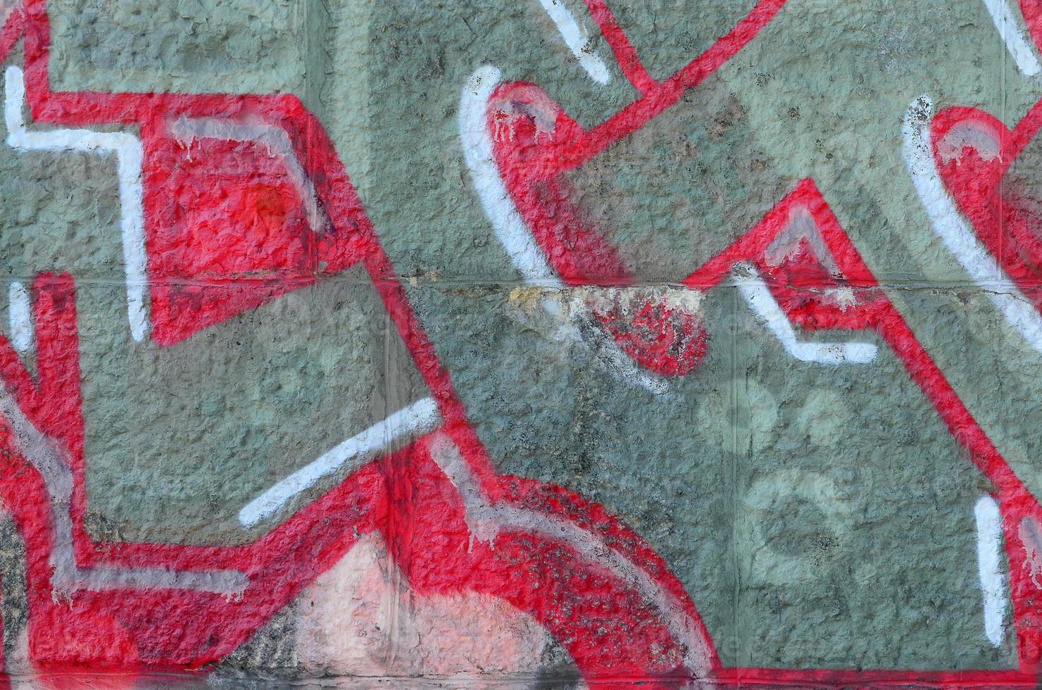 Fragment of graffiti drawings. The old wall decorated with paint stains in the style of street art culture. Colored background texture in warm tones photo