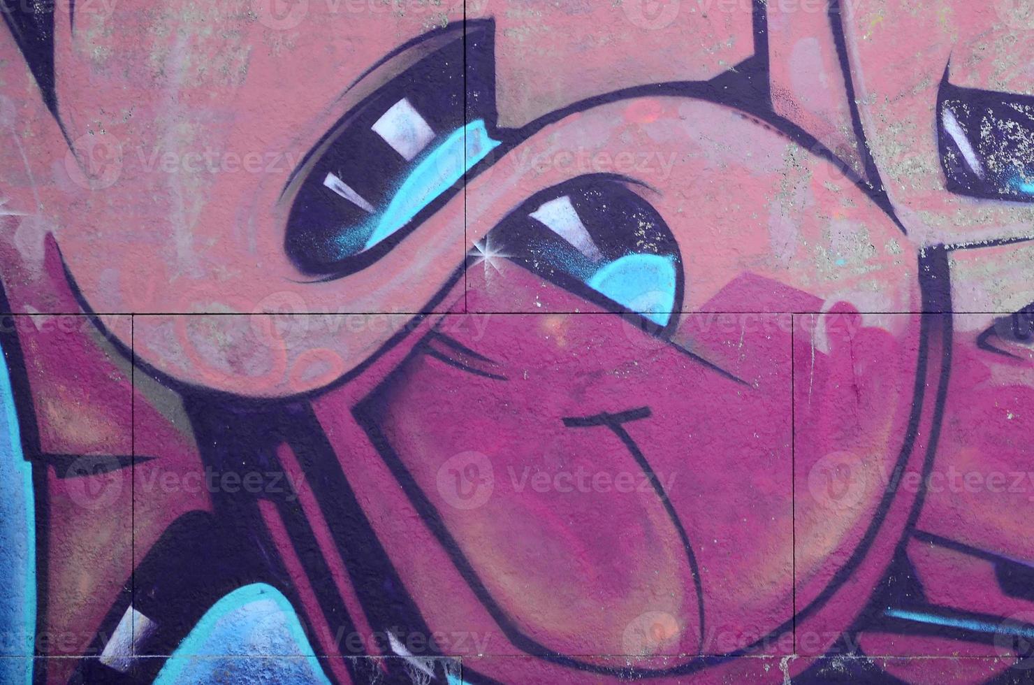 Fragment of graffiti drawings. The old wall decorated with paint stains in the style of street art culture. Colored background texture in warm tones photo