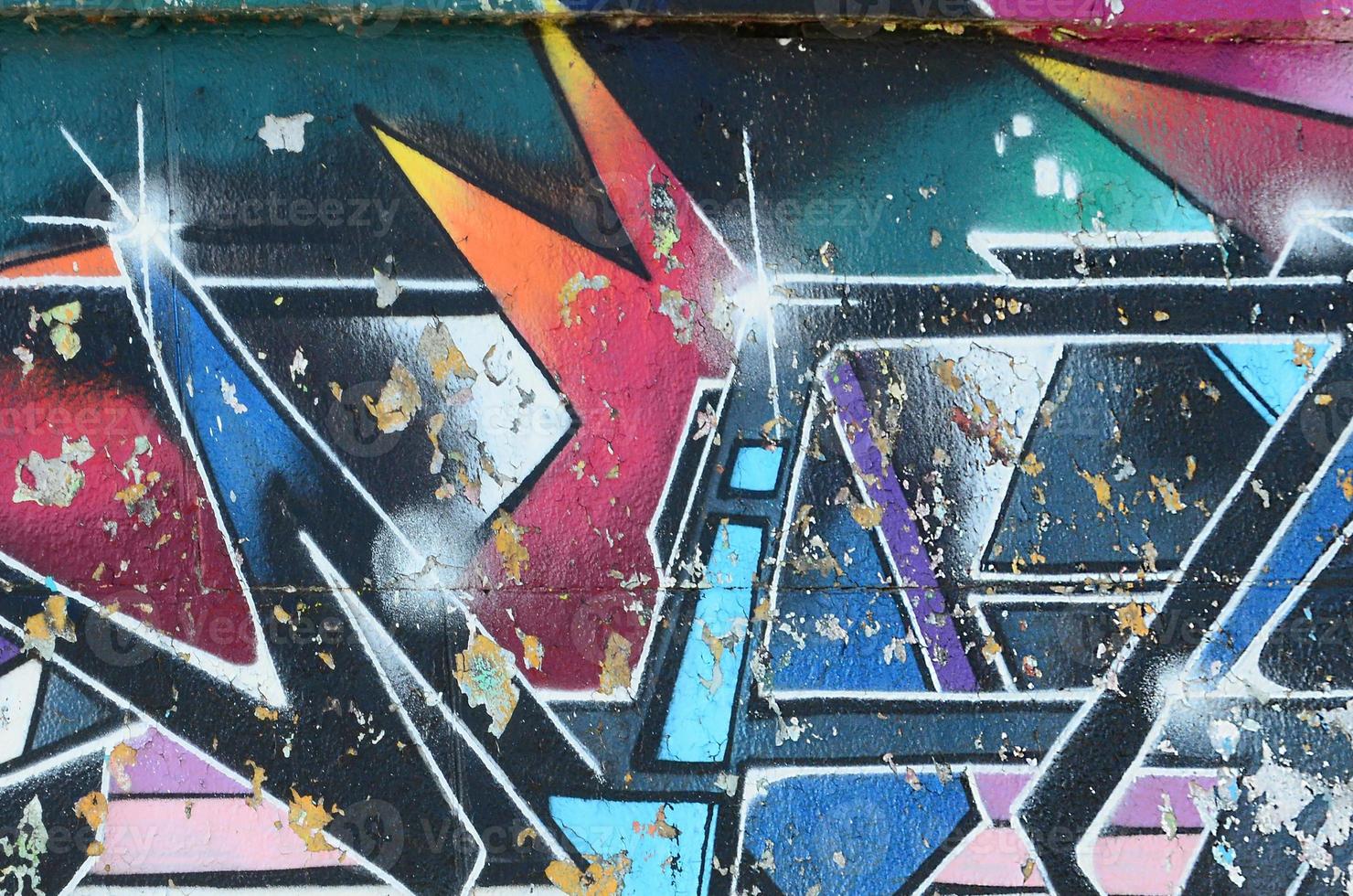 Fragment of graffiti drawings. The old wall decorated with paint stains in the style of street art culture. Multicolored background texture photo