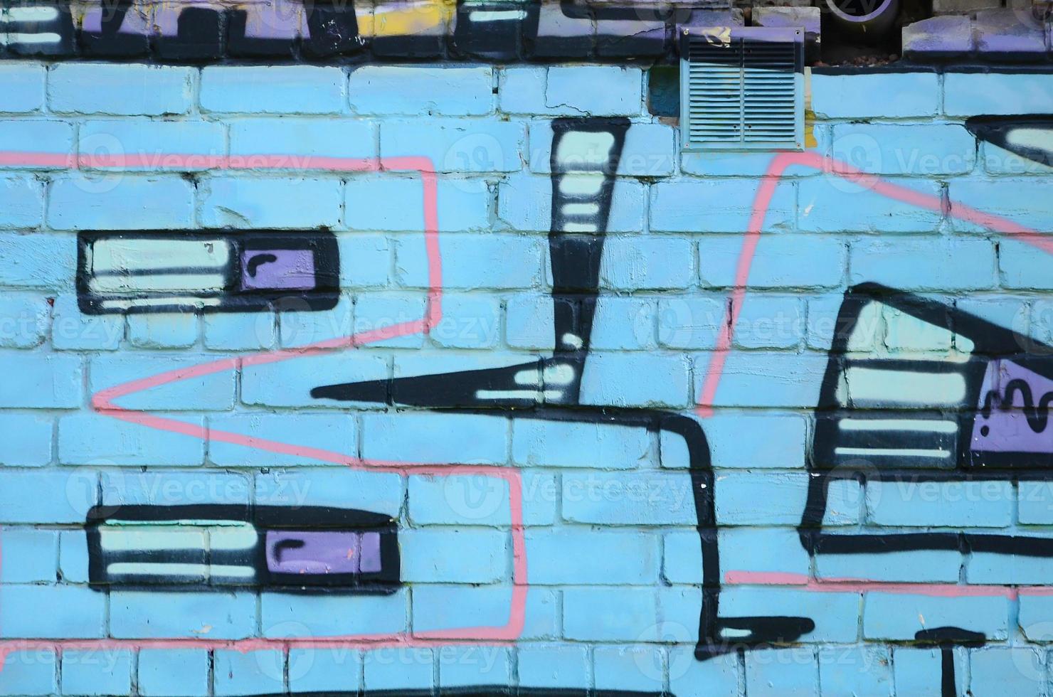 Fragment of graffiti drawings. The old wall decorated with paint stains in the style of street art culture. Colored background texture in cold tones photo