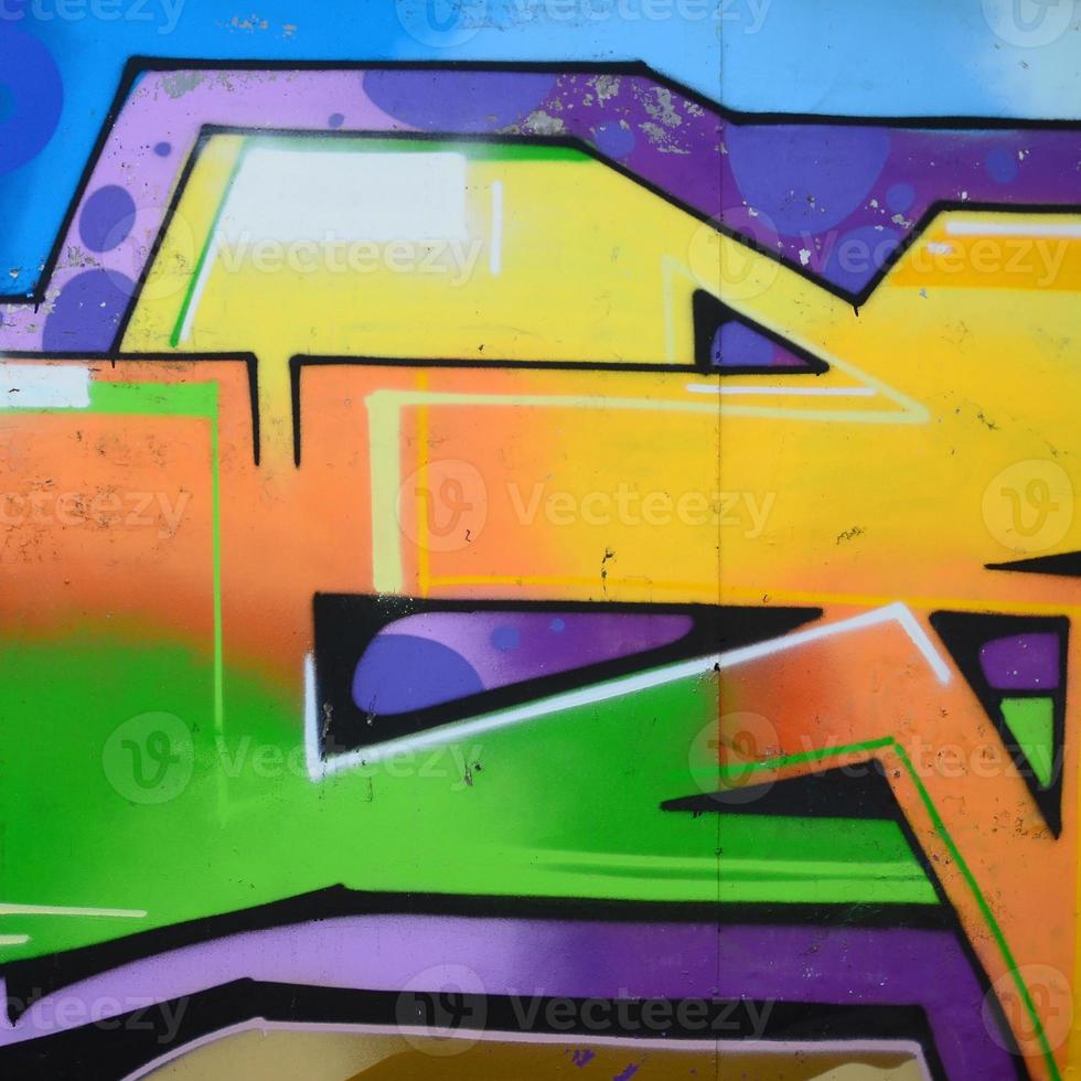 Fragment of graffiti drawings. The old wall decorated with paint stains in the style of street art culture. Multicolored background texture photo