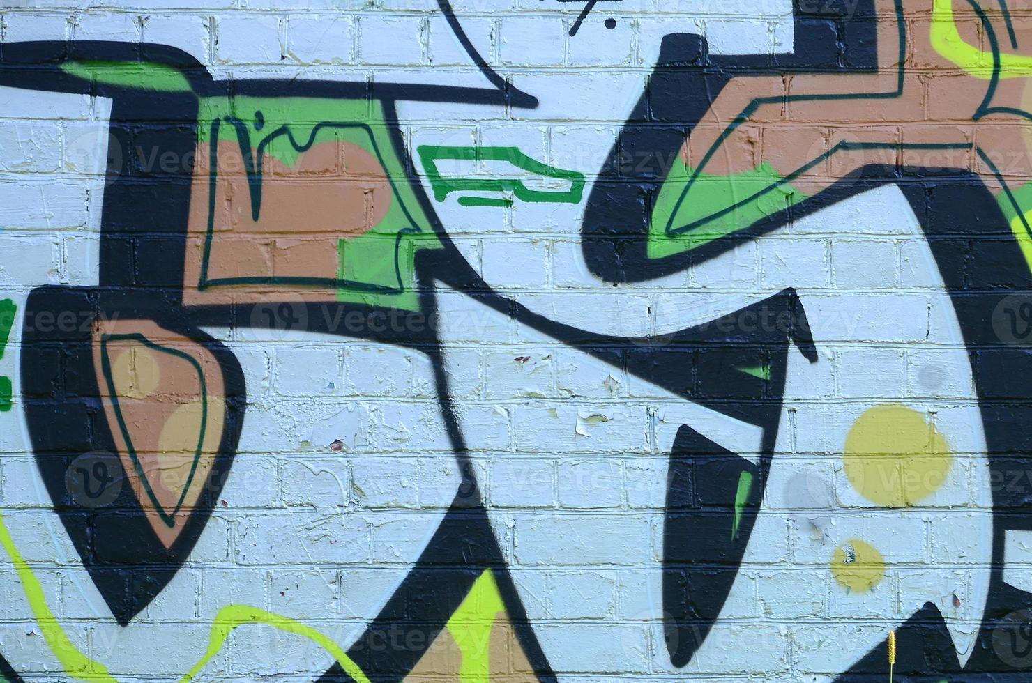 Fragment of graffiti drawings. The old wall decorated with paint stains in the style of street art culture. Colored background texture in green tones photo