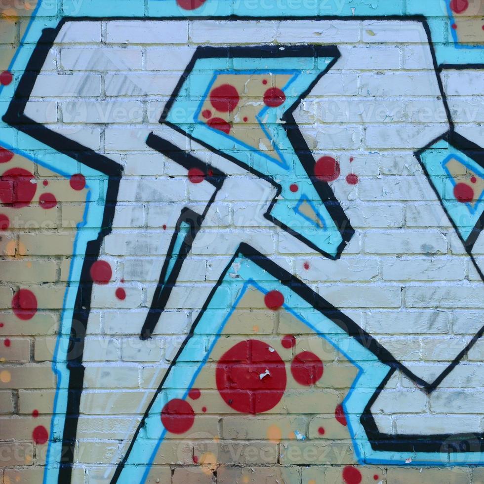 Fragment of graffiti drawings. The old wall decorated with paint stains in the style of street art culture. Colored background texture in cold tones photo
