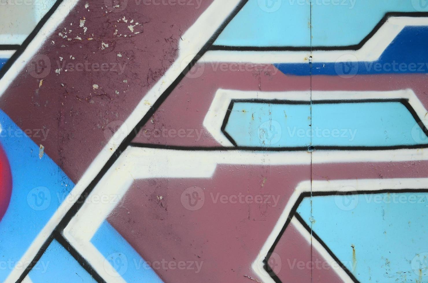 fragmento de dibujos de graffiti. la antigua muralla decorada con manchas de pintura al estilo de la cultura del arte callejero. textura de fondo coloreada en tonos fríos foto