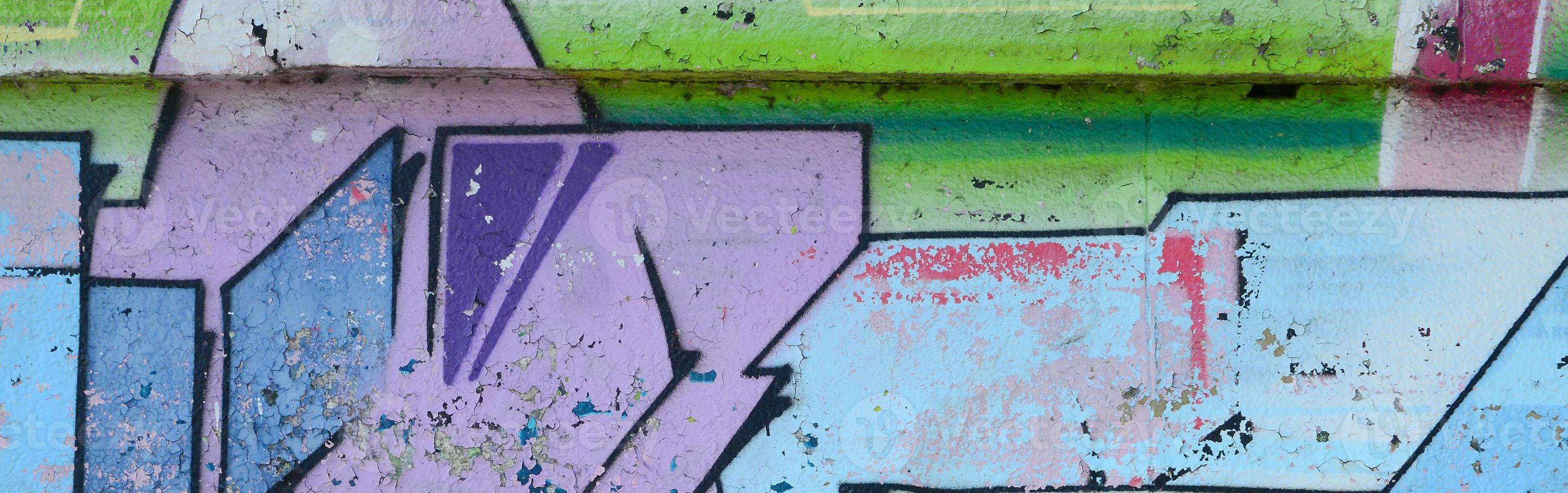 Fragment of graffiti drawings. The old wall decorated with paint stains in the style of street art culture. Colored background texture in cold tones photo