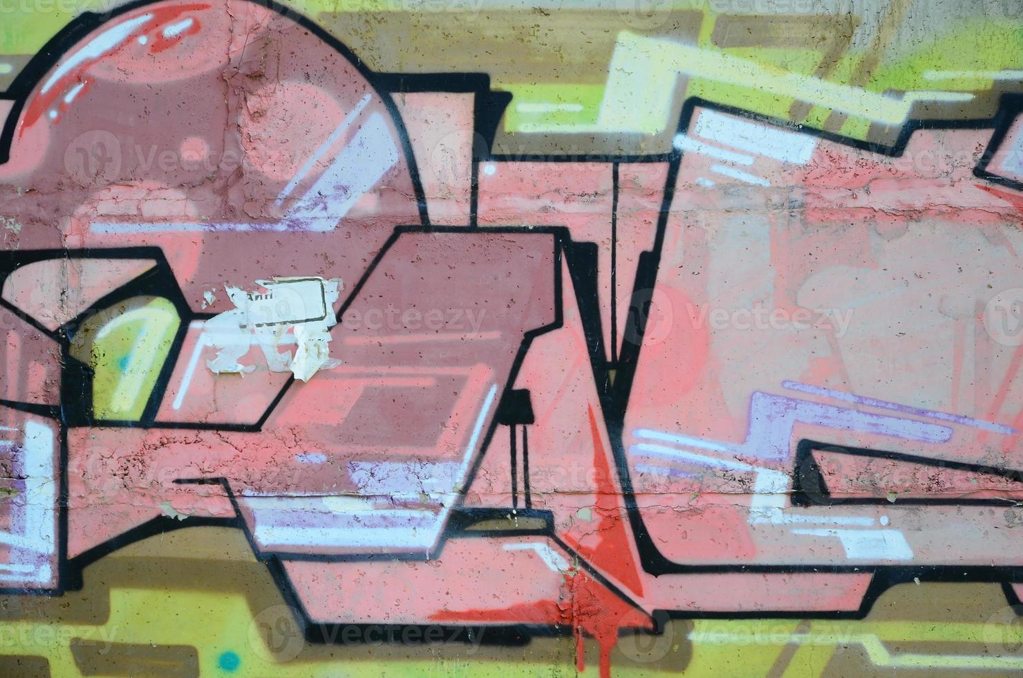 Fragment of graffiti drawings. The old wall decorated with paint stains in the style of street art culture. Colored background texture in warm tones photo