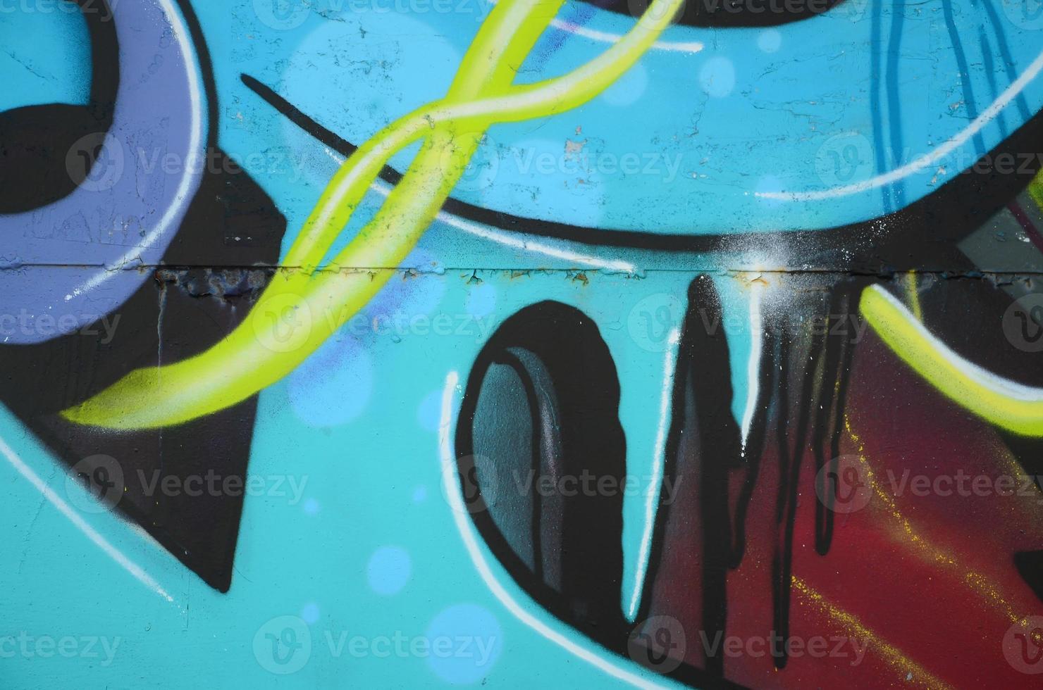 Fragment of graffiti drawings. The old wall decorated with paint stains in the style of street art culture. Colored background texture in cold tones photo