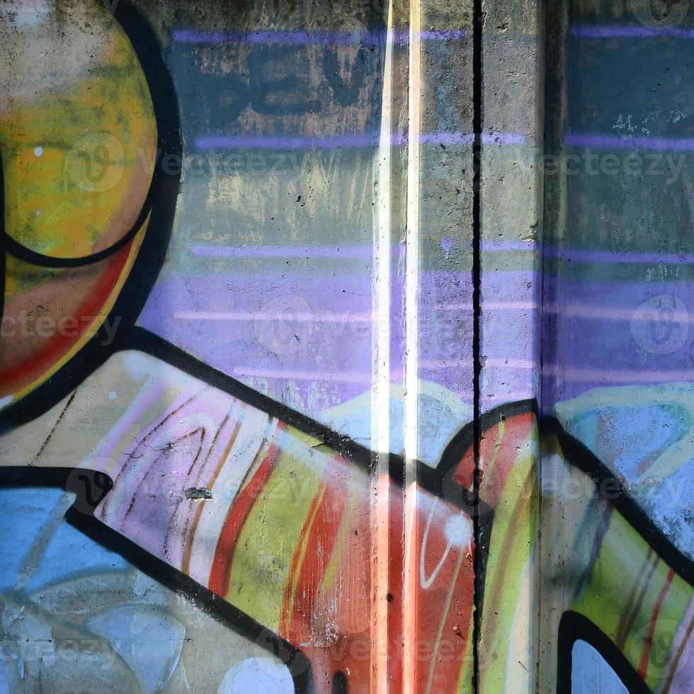 Fragment of graffiti drawings. The old wall decorated with paint stains in the style of street art culture. Multicolored background texture photo