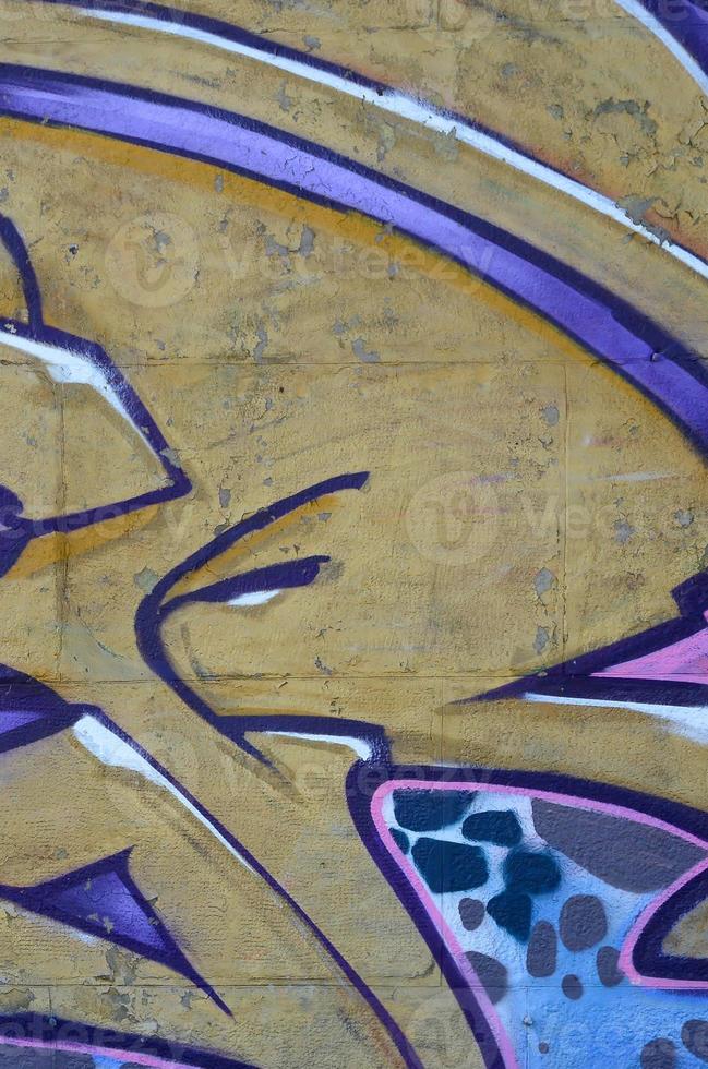 Fragment of graffiti drawings. The old wall decorated with paint stains in the style of street art culture. Colored background texture in purple tones photo