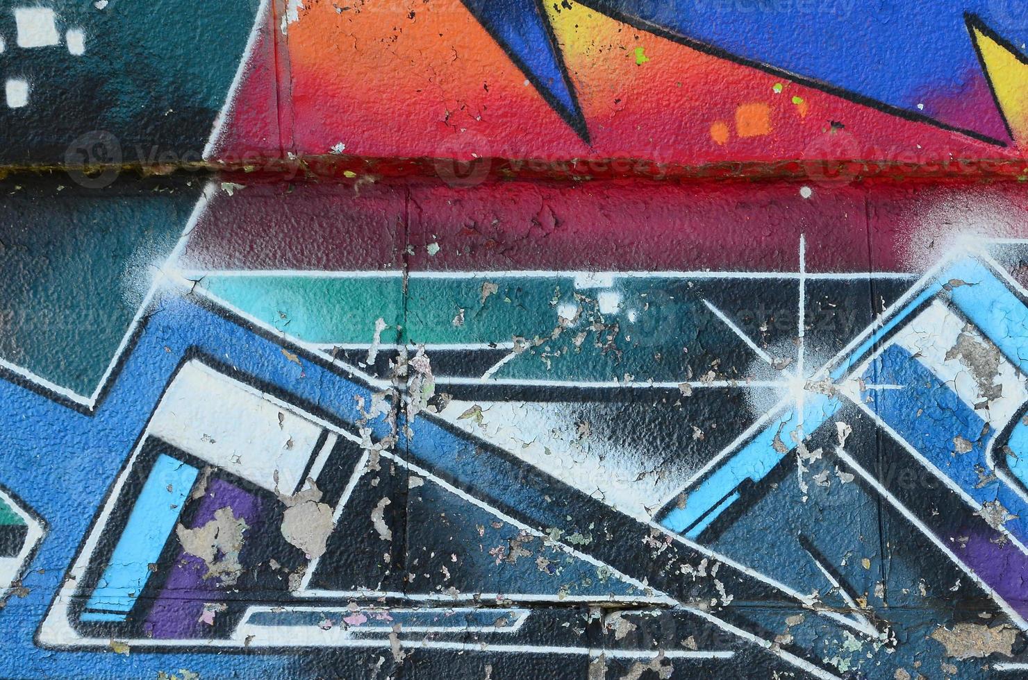Fragment of graffiti drawings. The old wall decorated with paint stains in the style of street art culture. Multicolored background texture photo