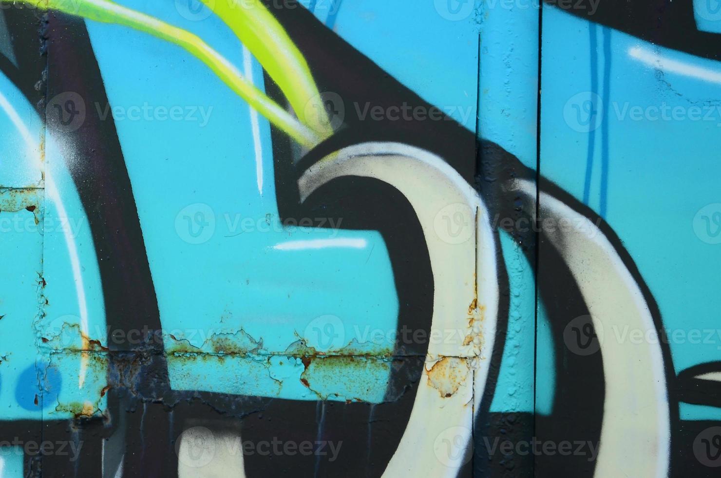 Fragment of graffiti drawings. The old wall decorated with paint stains in the style of street art culture. Colored background texture in cold tones photo