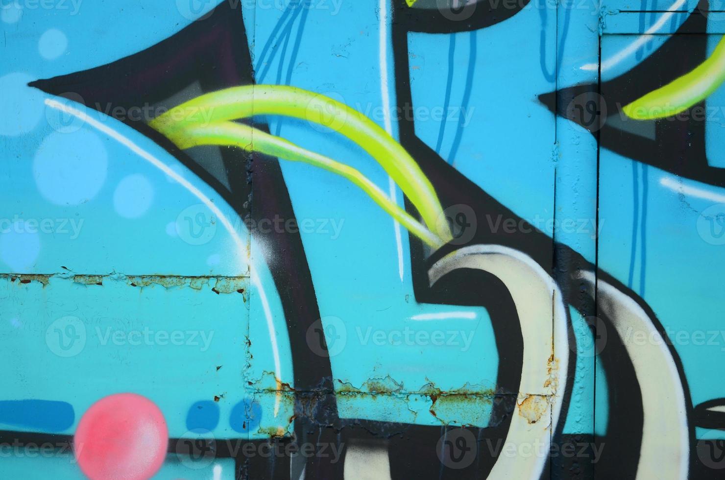 Fragment of graffiti drawings. The old wall decorated with paint stains in the style of street art culture. Colored background texture in cold tones photo