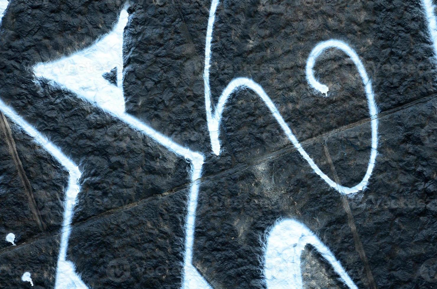 fragmento de dibujos de graffiti. la antigua muralla decorada con manchas de pintura al estilo de la cultura del arte callejero. textura de fondo de color foto