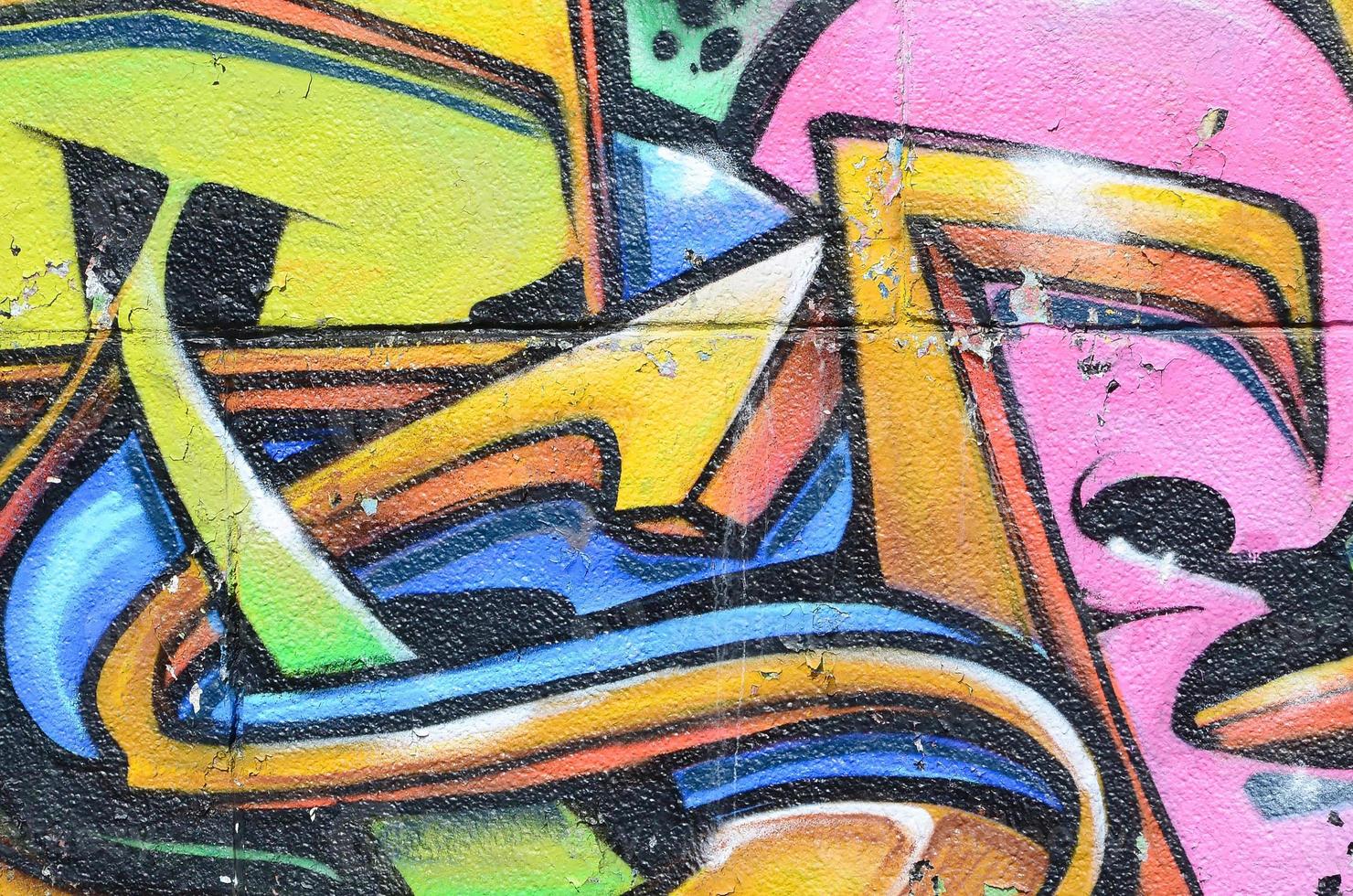 Fragment of graffiti drawings. The old wall decorated with paint stains in the style of street art culture. Multicolored background texture photo